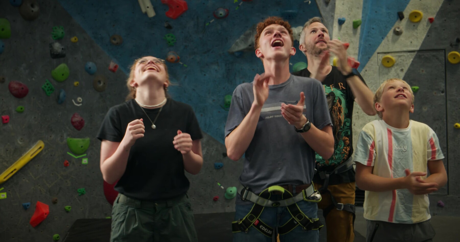 The group cheers and looks up in delight during a climb.